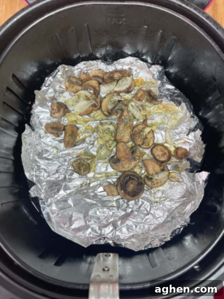 sautéed mushrooms with shallots and garlic cooking in foil in an air fryer