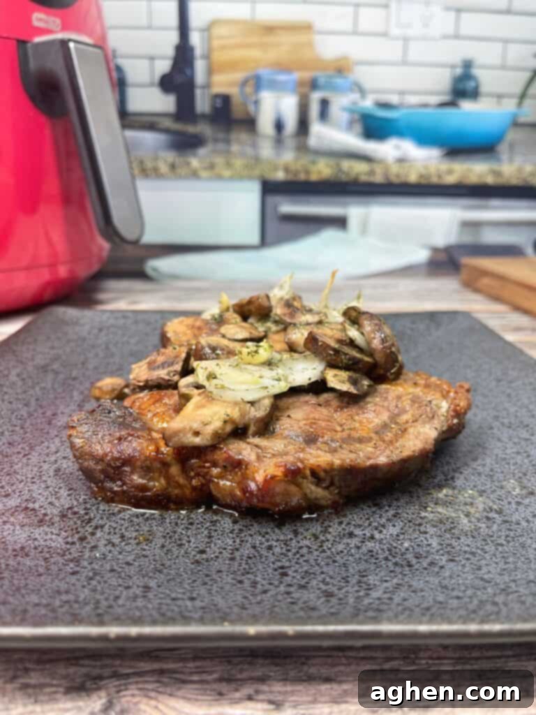 close-up of cooked ribeye steak with sautéed garlic mushrooms on top