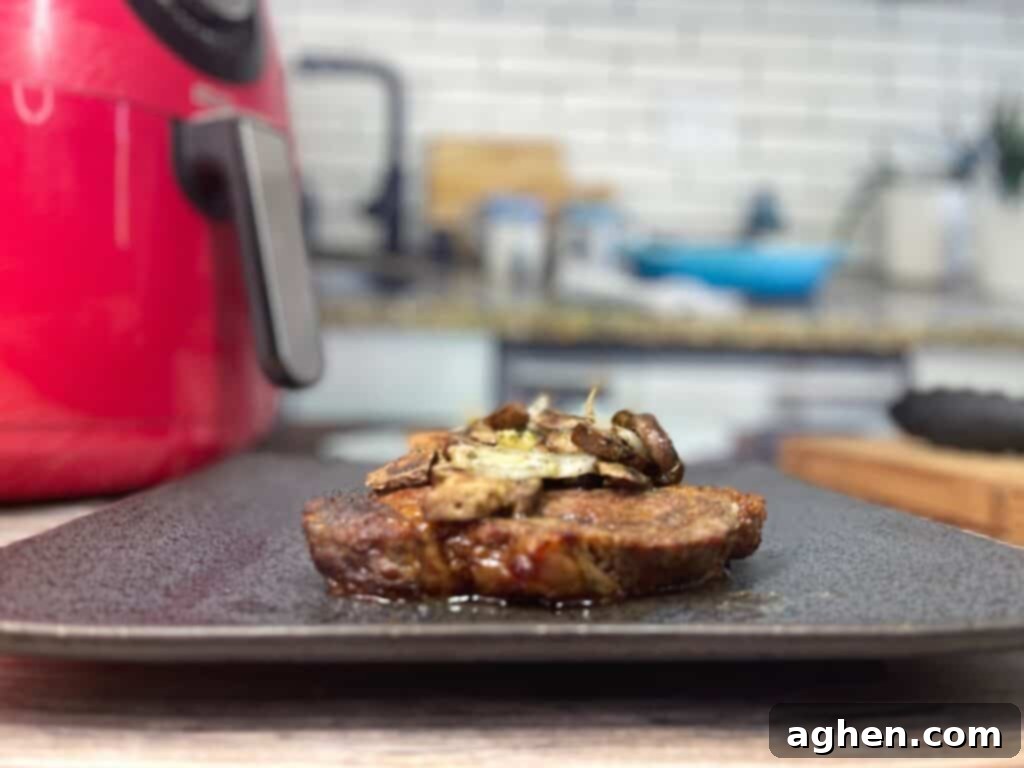 overhead view of juicy cooked ribeye steak with golden brown sautéed mushrooms