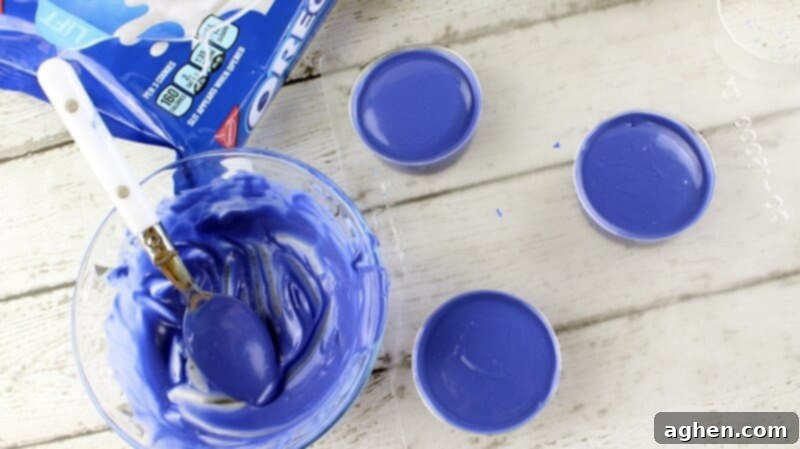 Blue melted candy covering the top of the oreo cookies in the candy mold.