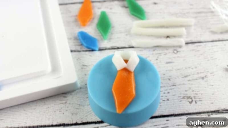 Ties placed on chocolate covered cookies with the white strips folded around the top of the ti shape to look like a collar.