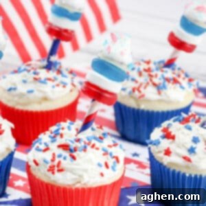 Firecracker cupcakes decorated with red, white, and blue firecrackers on top made out of candy.