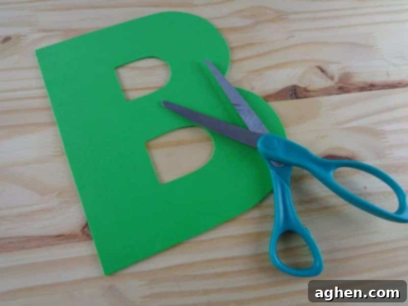 Tracing and cutting the letter B from craft foam for the Letter B is for Bus craft.