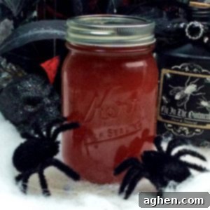 Crimson Silk Spirit 4 Close-up of Black Widow Venom Halloween moonshine in a mason jar, showcasing its rich red color.