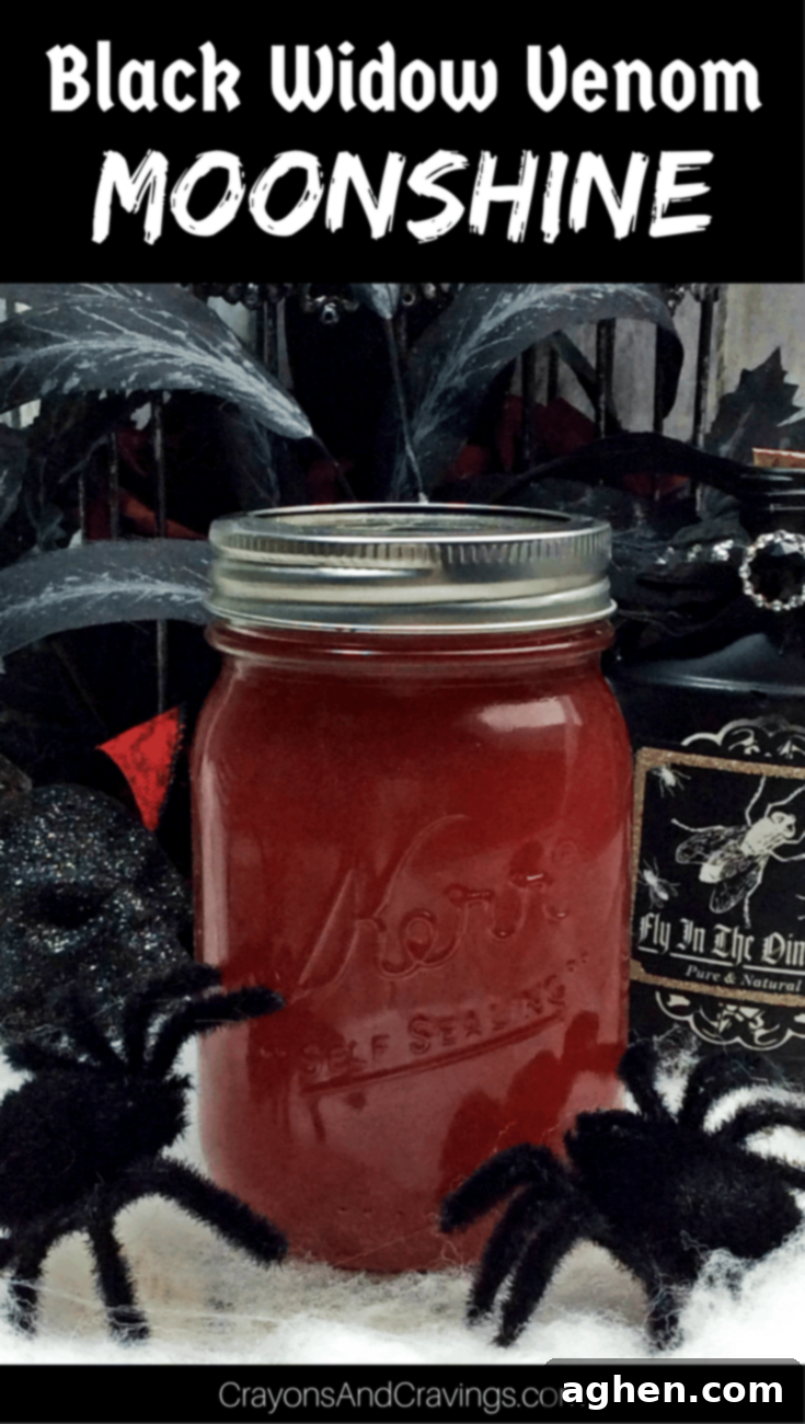 Crimson Silk Spirit 6 A beautifully illuminated glass mason jar filled with cinnamon strawberry moonshine, highlighting its rich color and inviting texture, ready to be served.
