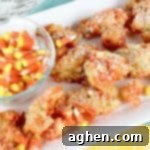 Funfetti Fried Candy Corn Bites 14 Deep fried candy corn fritters next to bowl of candy corn.