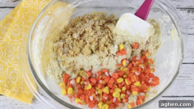 Funfetti Fried Candy Corn Bites 9 Chopped candy corn and frosted flake cereal added to the batter in the mixing bowl,
