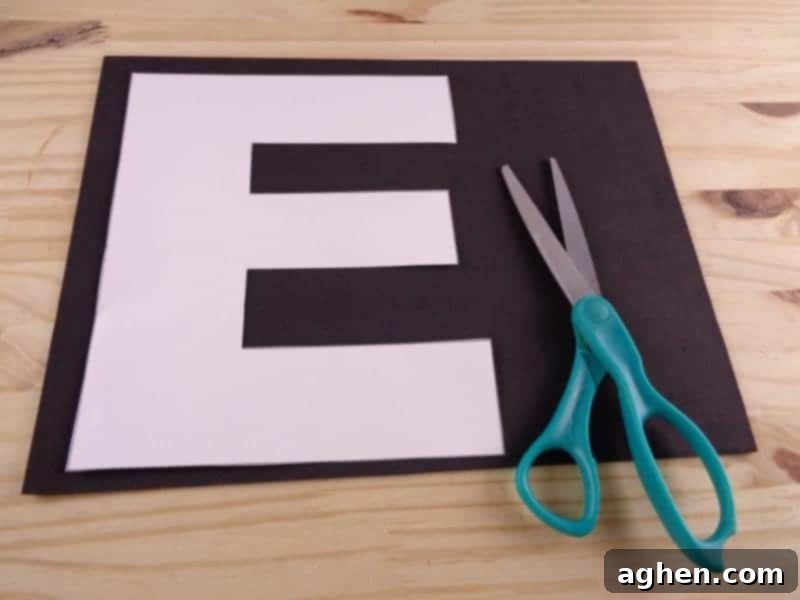 Trace the cut-out Letter E template onto your chosen craft foam or colored cardstock, preparing it for the next cutting phase.
