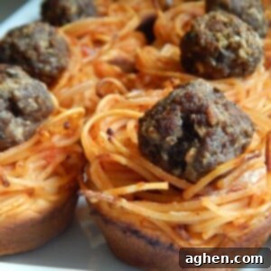 Spaghetti & Meatball Biscuit Pot Pies 2 Weight Watchers friendly spaghetti and meatball mini pies in a muffin tin