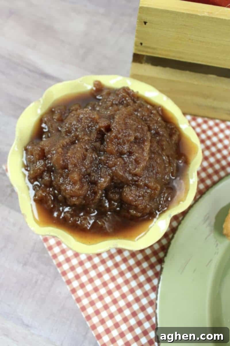 A jar of freshly made homemade crockpot apple butter, ready for enjoyment or gifting.
