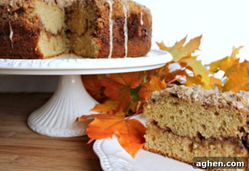 Slice of Maple Walnut Coffee Cake with maple icing drizzle, showcasing the streusel and cream cheese layer.