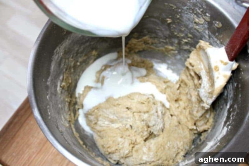 Buttermilk being gently folded into the coffee cake batter.