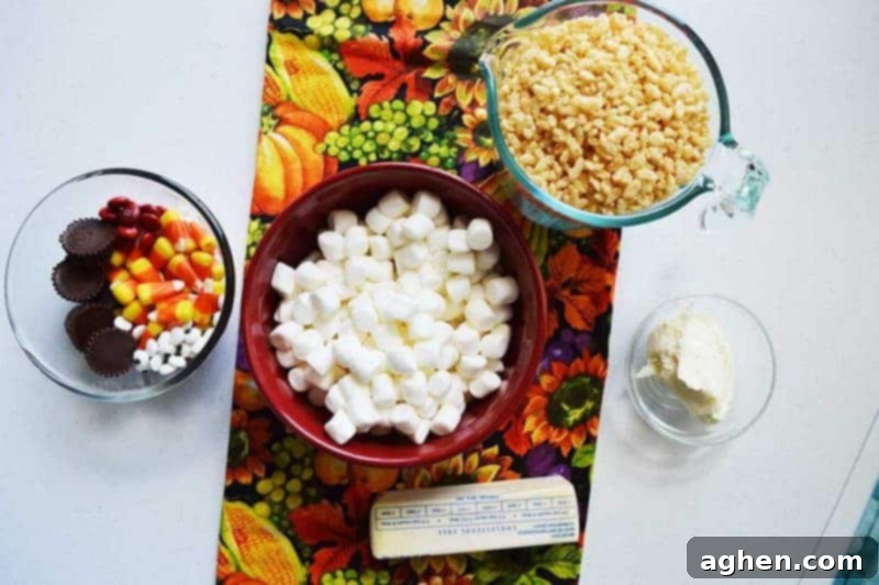 Ingredients laid out for Rice Krispie Turkey Treats: Rice Krispies cereal, butter, mini marshmallows, mini peanut butter cups, candy eyes, red M&M’s, and candy corn.