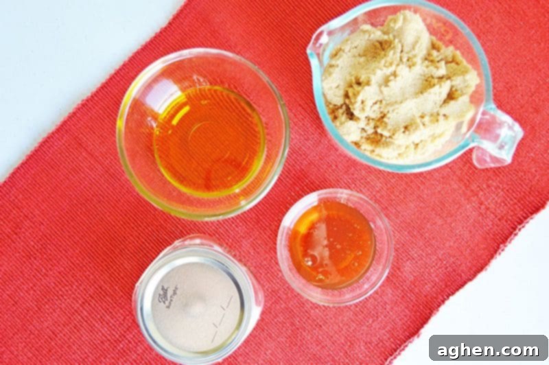 The three natural ingredients for DIY brown sugar scrub: brown sugar, olive oil, and honey, laid out for an easy homemade body care recipe.