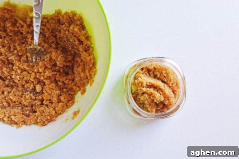Stirring the brown sugar, olive oil, and honey mixture until it forms a uniform, rich brown sugar scrub texture.