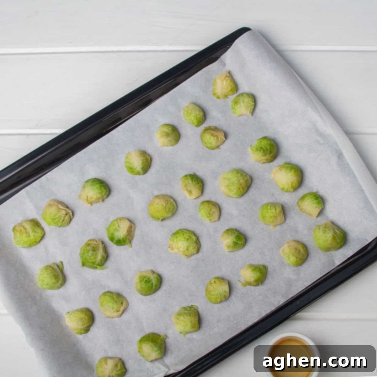 Red Lobster Style Crispy Brussels Sprouts 4 Halved Brussels sprouts spread evenly on a parchment-lined baking sheet, ready for roasting.