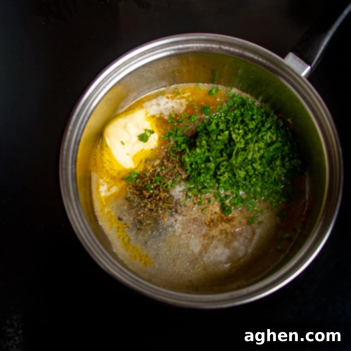 Melted butter, chicken stock, chopped parsley, crushed garlic, Italian herbs, lemon juice, lemon zest, salt, and pepper in a hot skillet.