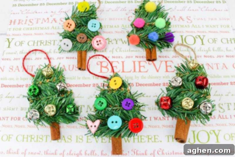 A fun DIY Christmas Tree Ornament craft, made using wreath garland, cinnamon sticks, twine, buttons, pom poms and jingle bells, hanging on a tree.