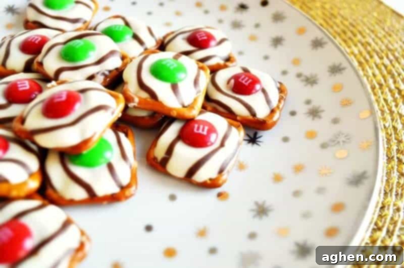 Salty-sweet Christmas pretzel hugs treats are quick and easy to make with just 3 ingredients: square pretzels, M&Ms, and Hershey's Hugs.