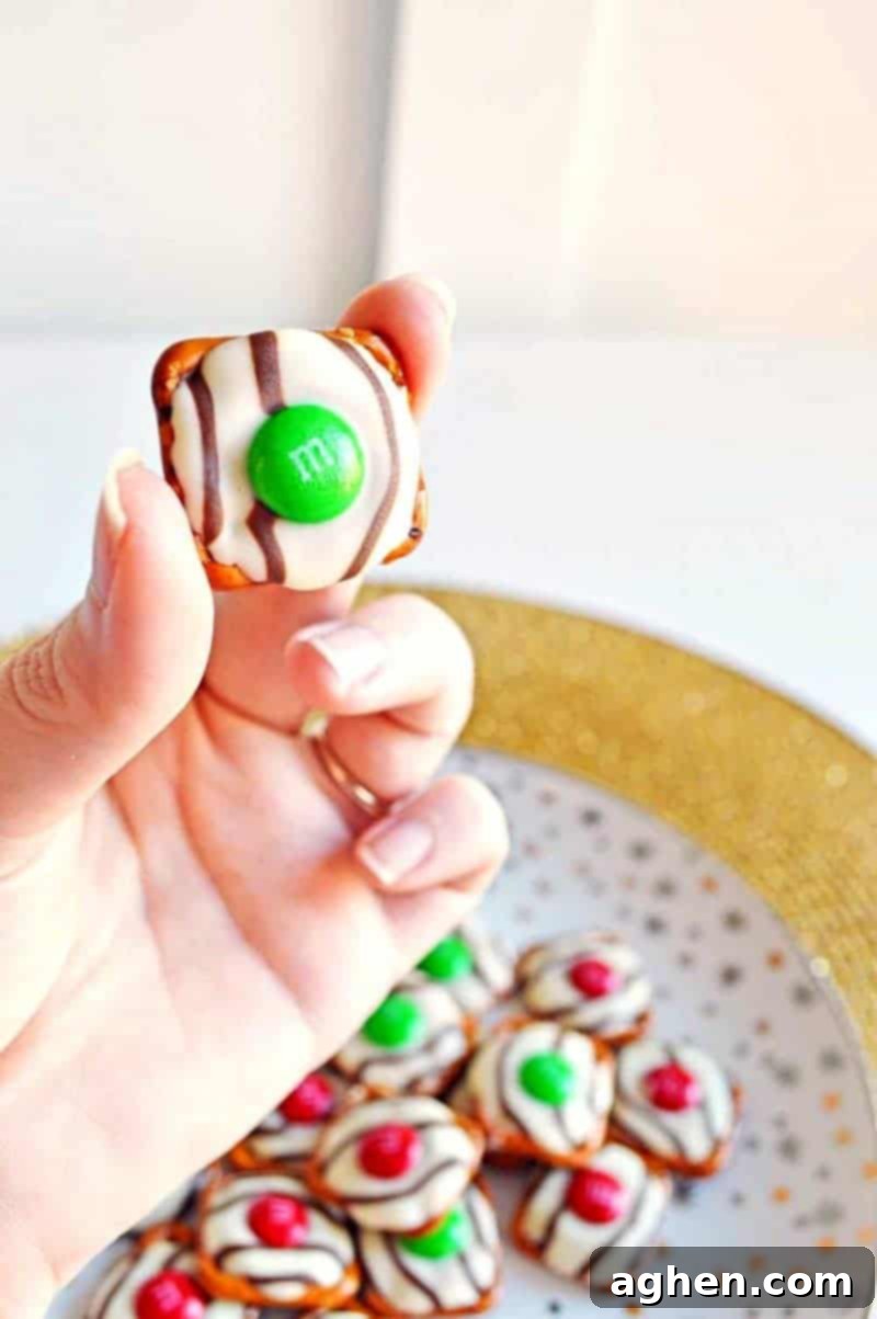 Salty-sweet Christmas pretzel hugs treats are quick and easy to make with just 3 ingredients: square pretzels, M&Ms, and Hershey's Hugs.