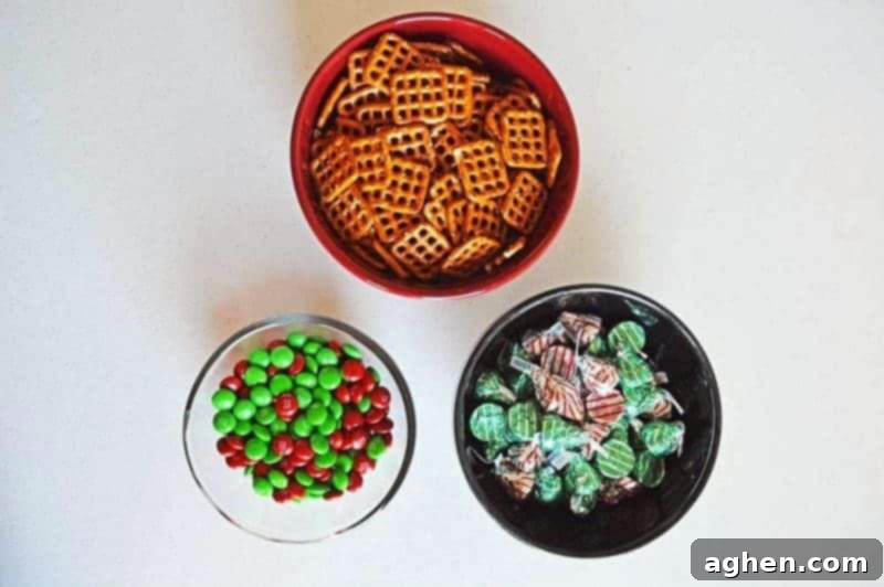 Salty-sweet Christmas pretzel hugs treats are quick and easy to make with just 3 ingredients: square pretzels, M&Ms, and Hershey's Hugs.