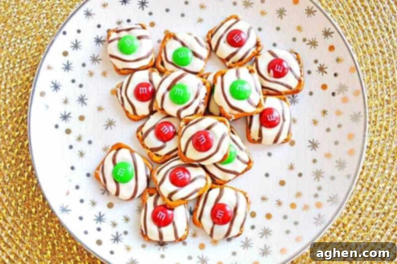 Salty-sweet Christmas pretzel hugs treats are quick and easy to make with just 3 ingredients: square pretzels, M&Ms, and Hershey's Hugs.