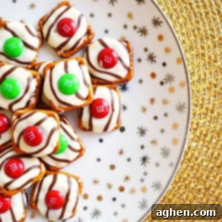 Salty-sweet Christmas pretzel hugs treats are quick and easy to make with just 3 ingredients: square pretzels, M&Ms, and Hershey's Hugs.