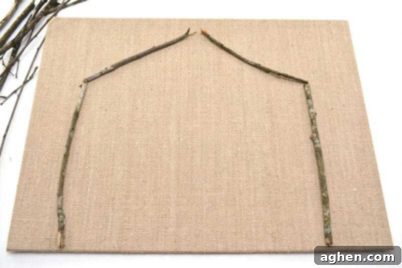 Laying out twigs for the stable structure on the burlap canvas.