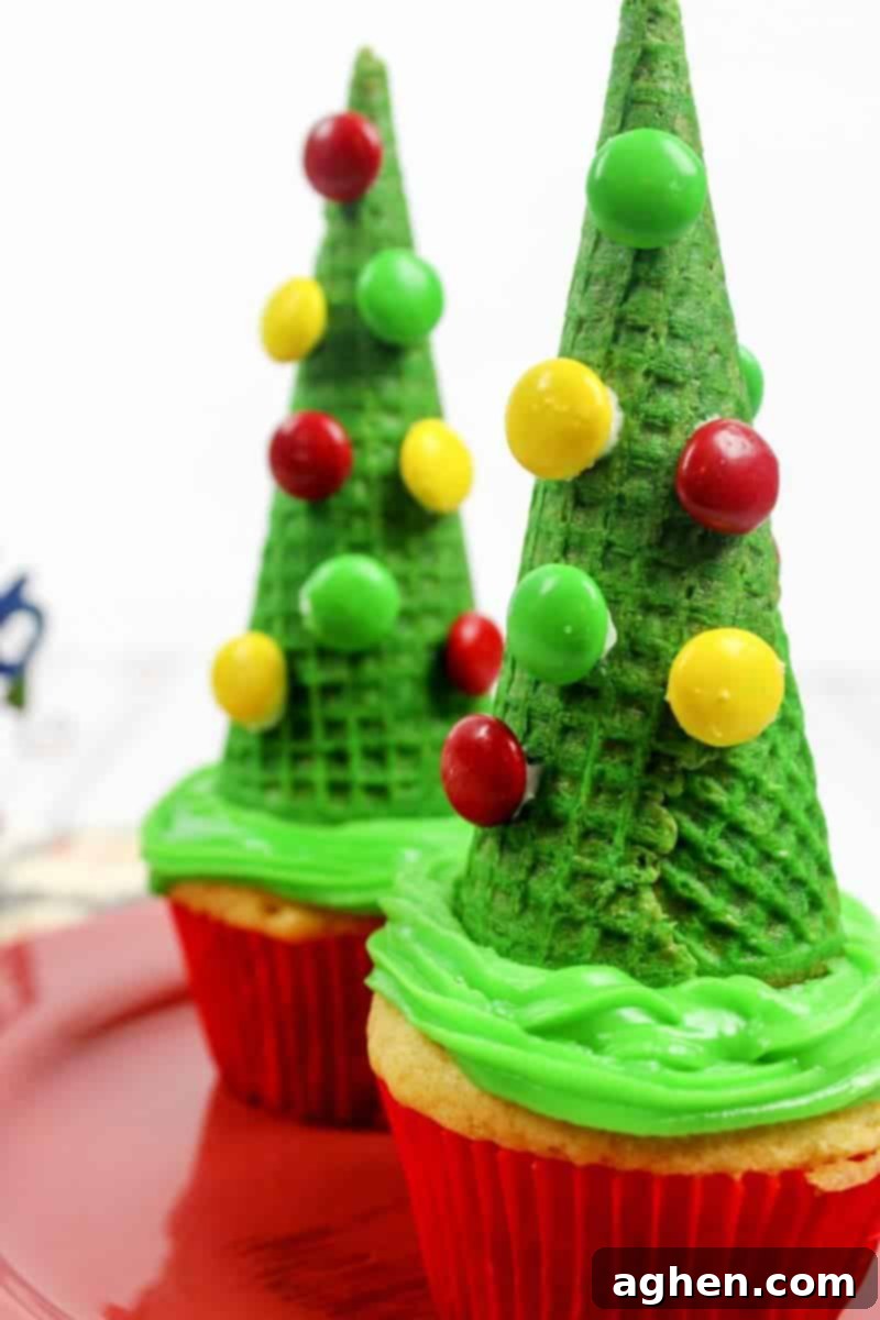 Delicious and easy-to-make Christmas tree cupcakes topped with sugar cones and festive M&M ornaments, perfect for holiday celebrations.