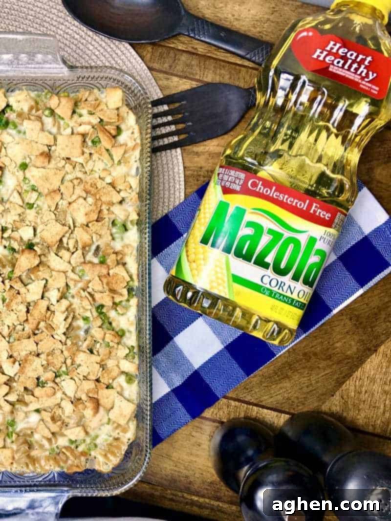 Close-up of the ingredients for a healthier tuna pasta casserole, including multi-grain pasta, low-fat soup, Mazola Corn Oil, and drained tuna, ready for mixing.