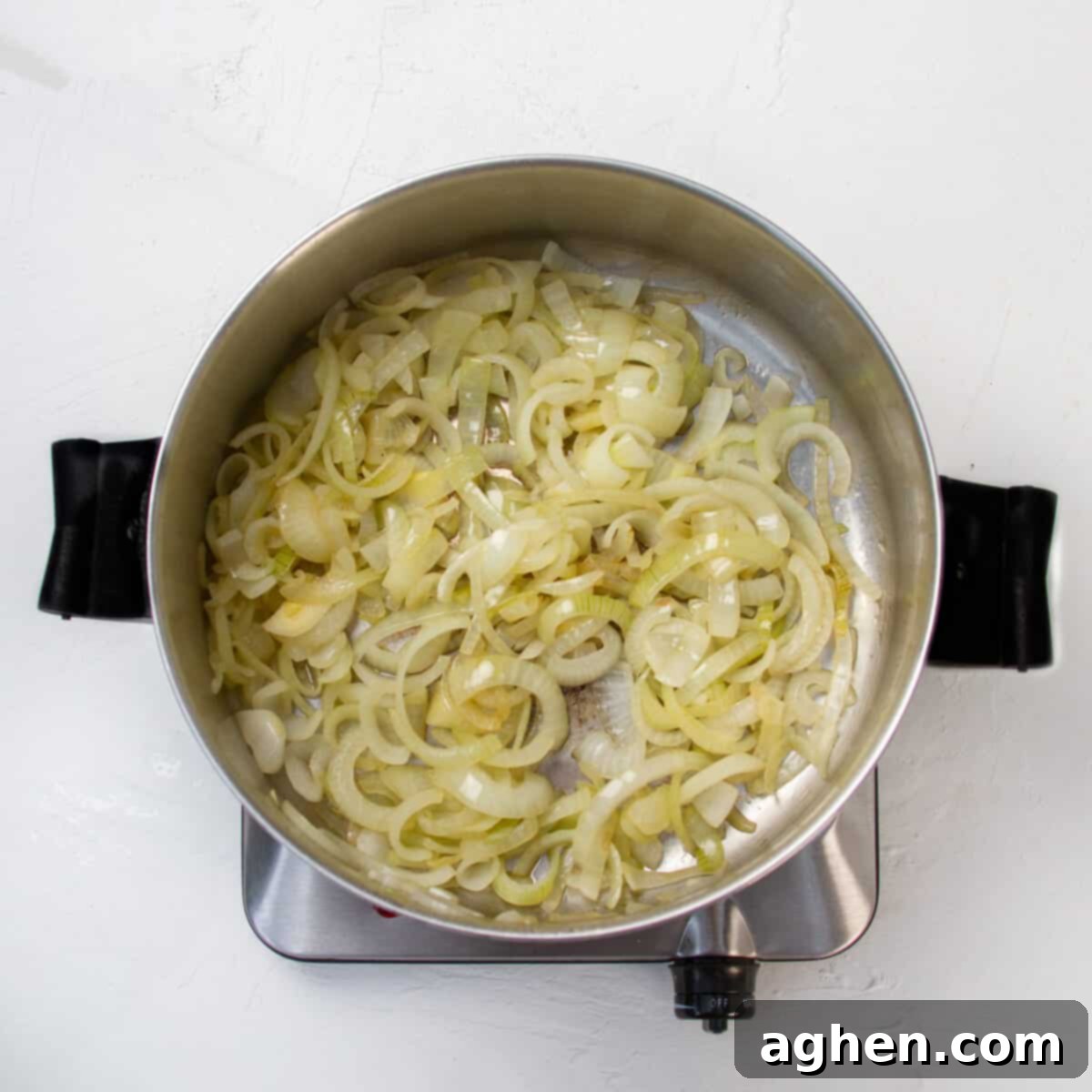 Savory WW Friendly French Onion Soup 5 Onions cooking in a hot pan.
