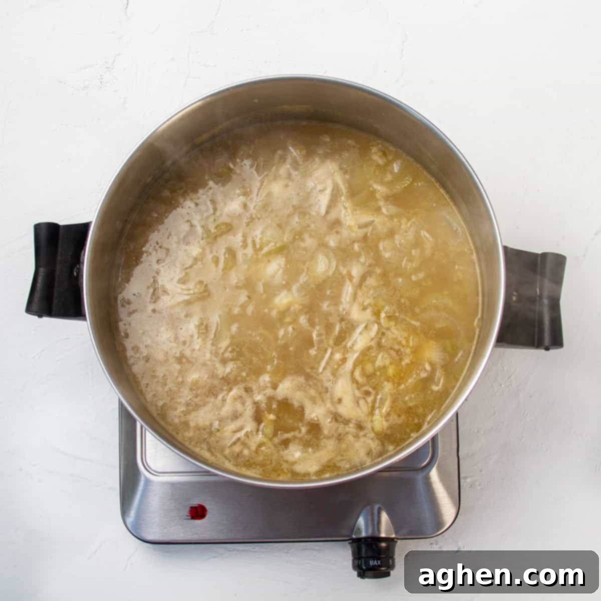 Savory WW Friendly French Onion Soup 6 Caramelized onions in broth, cooking in a hot pan.