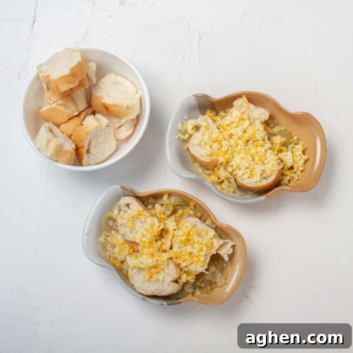 Savory WW Friendly French Onion Soup 7 Two bowls prepared with slices of bread and shredded cheese.