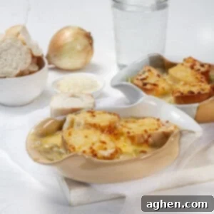Savory WW Friendly French Onion Soup 8 French onion soup in two bowls topped with bread and melted cheese.