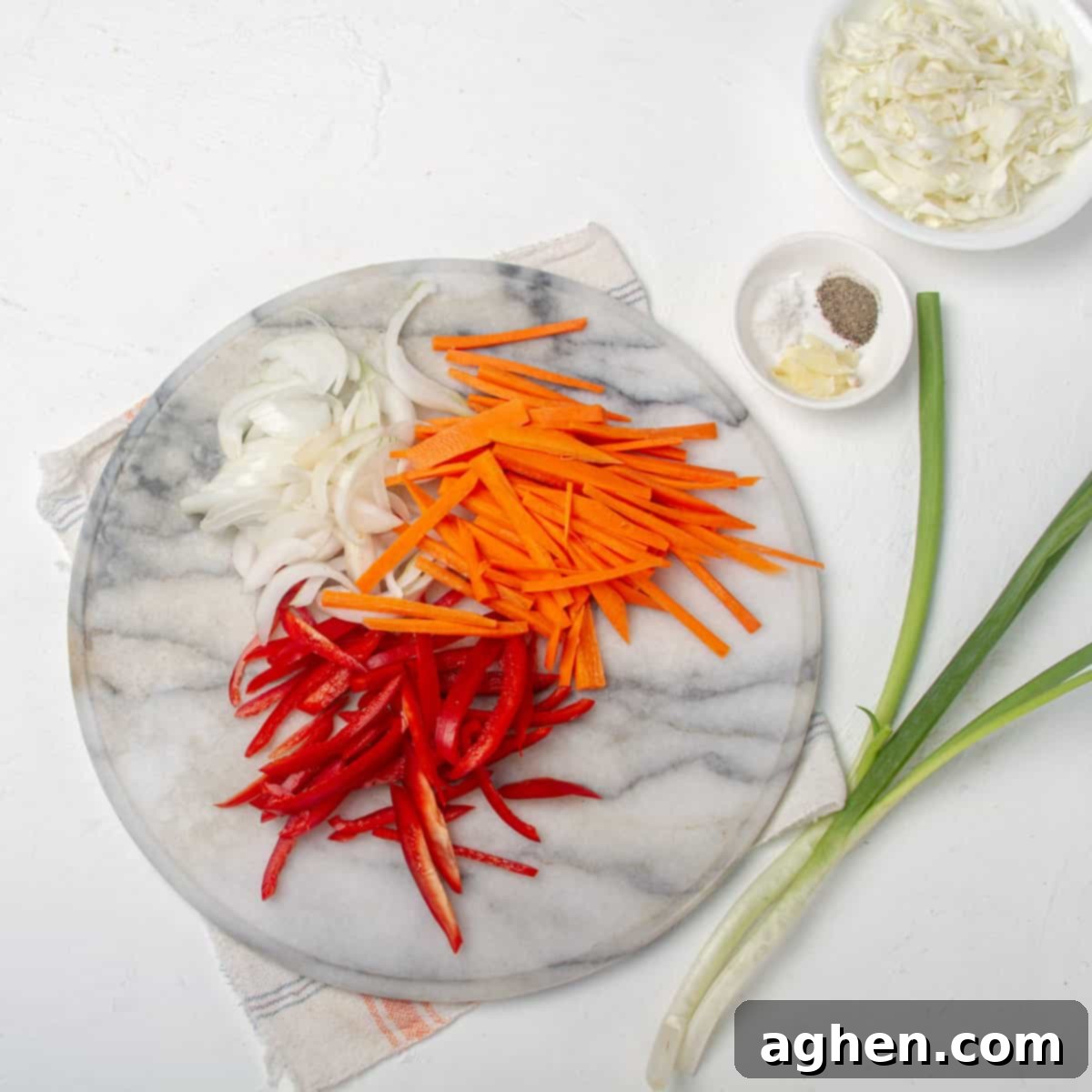 Thai Pad Woon Sen Stir Fry 4 Re bell pepper, carrots, and onion chopped into matchsticks on a cutting board.
