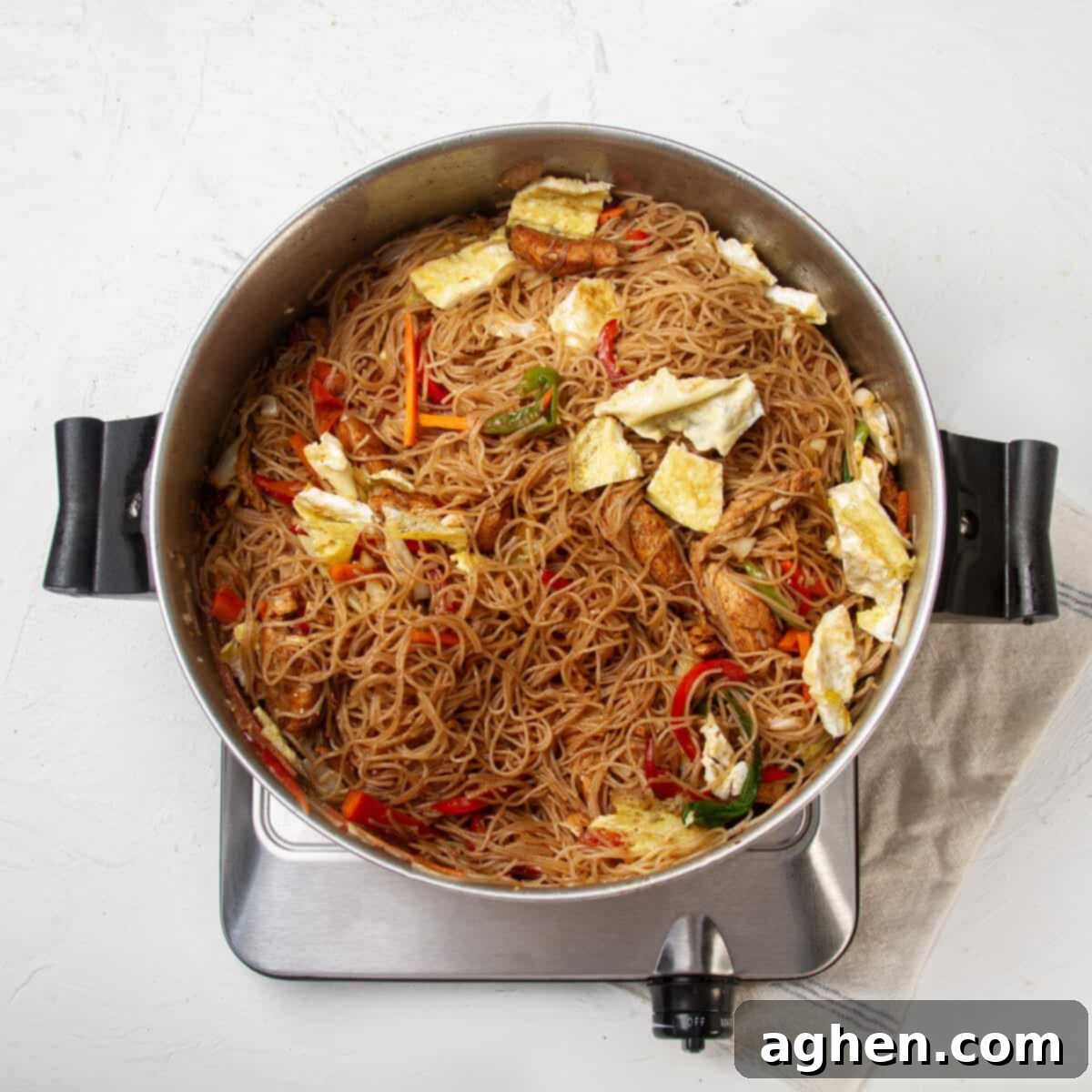 Thai Pad Woon Sen Stir Fry 9 Glass noodles with chicken and vegetables in a pan.
