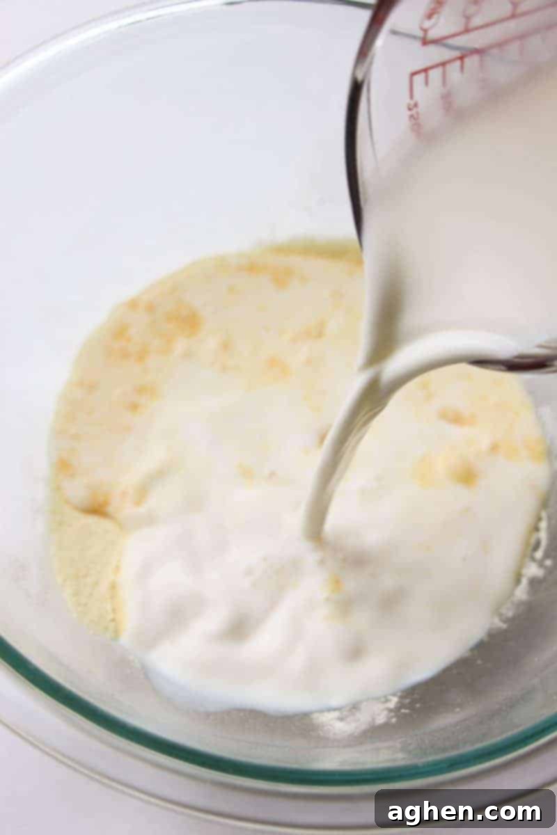 Mixing instant banana pudding with milk until it begins to thicken, preparing the creamy filling for the cookie cups.