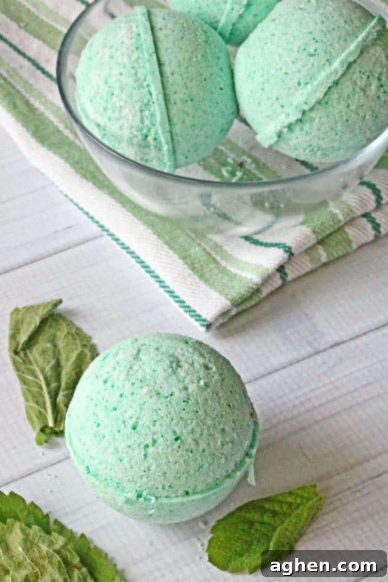 A close-up view of a single, perfectly spherical DIY headache bath bomb, highlighting its smooth texture and vibrant color, ready to be dropped into a warm bath for a natural, soothing experience.