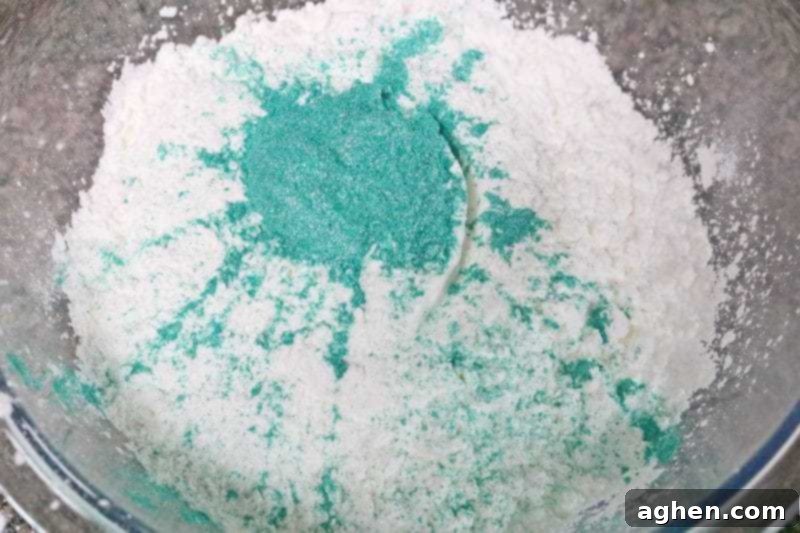 Step 1: All dry ingredients for the DIY headache bath bombs are carefully combined in a large glass mixing bowl, ensuring a uniform and clump-free mixture for optimal results.