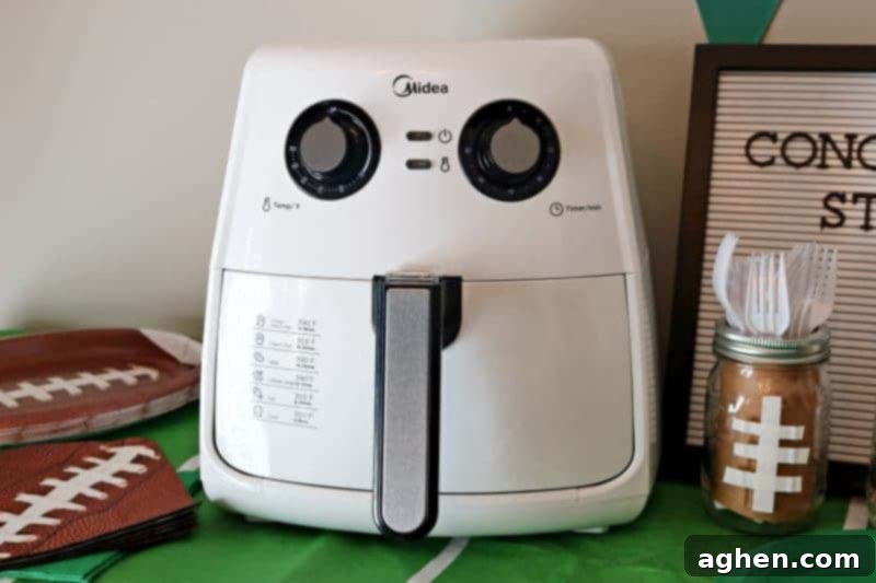 The Midea Air Fryer, showcasing its ability to produce delicious, crispy 'fried' foods with significantly less fat, perfect for Game Day snacks.