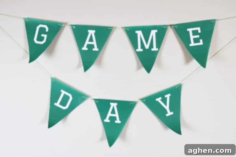 The completed Game Day banner being strung with twine, ready to be hung as party decor.