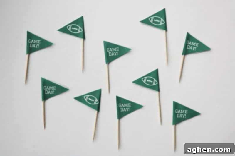 Multiple completed DIY Game Day toothpick toppers, ready to be used in party food.