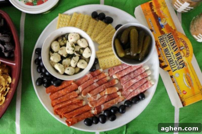 An elegant Game Day charcuterie board featuring savory Formaggio Italian Cheeses, crackers, olives, and gherkin pickles, perfect for a football party.