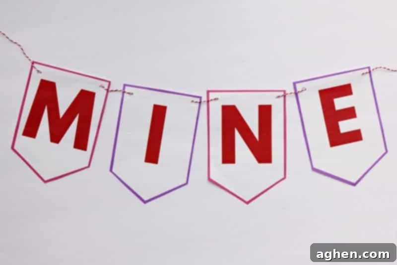 Stringing the "Be Mine" letter flags together to form the DIY Valentine banner.