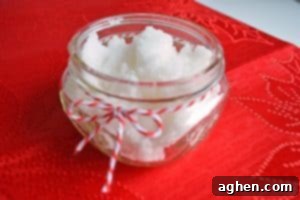 Homemade peppermint sugar scrub in a glass mason jar with ribbon.