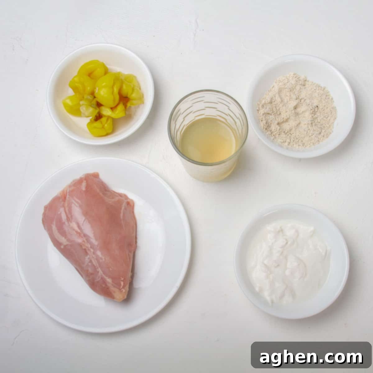 Mississippi Chicken Magic: Your Effortless Slow Cooker Dinner Solution 3 Raw chicken breast, gravy mix, plain yogurt, chicken broth, pickled peppers, and pickled pepper juice.