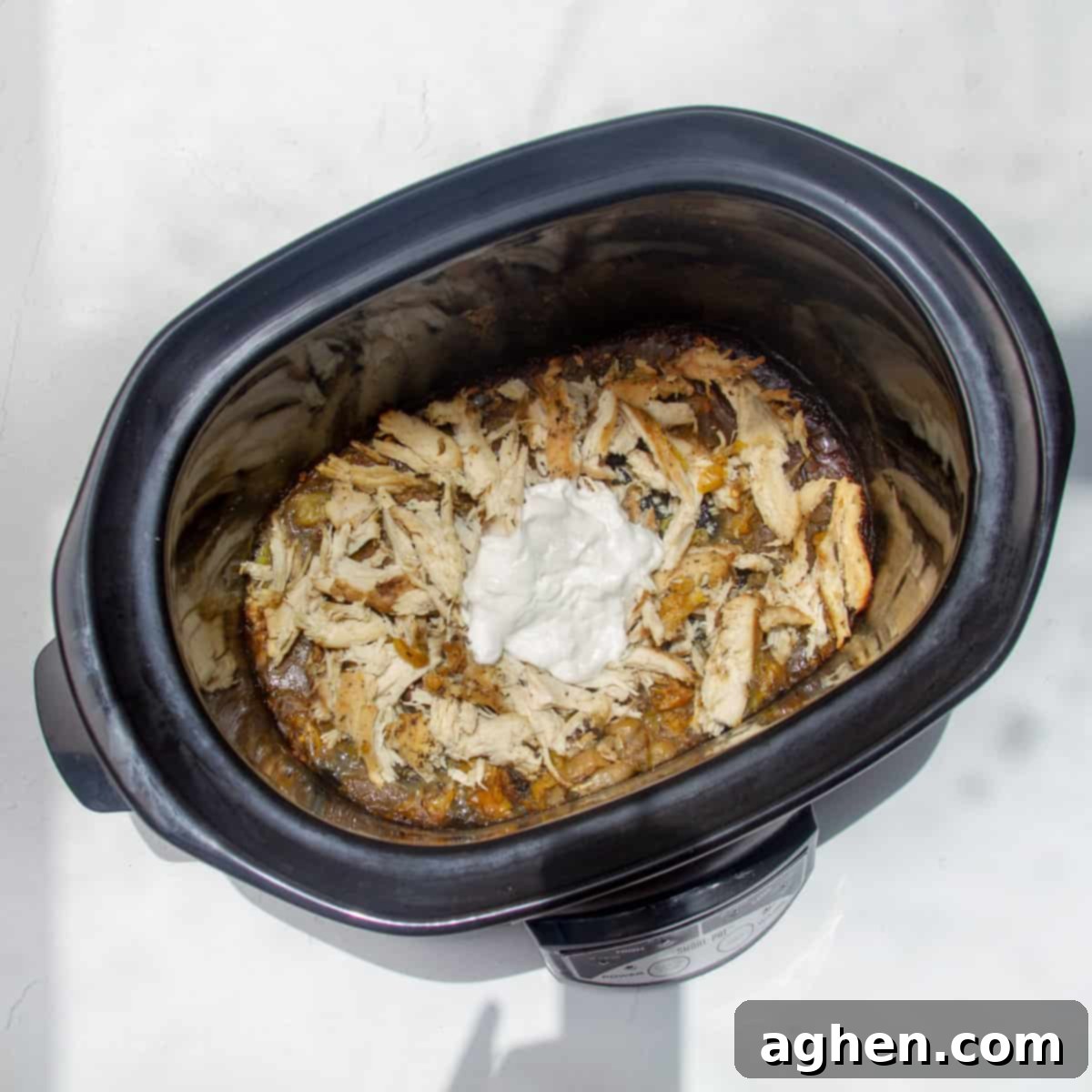 Mississippi Chicken Magic: Your Effortless Slow Cooker Dinner Solution 5 Cooked and shredded Mississippi chicken in a slow cooker.