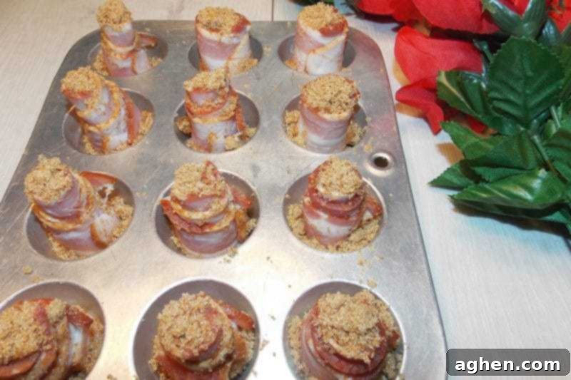 Brown sugar and cayenne pepper sprinkled on rolled bacon in a mini muffin tin, prior to baking.