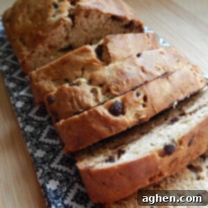 A slice of chocolate chip zucchini loaf on a plate