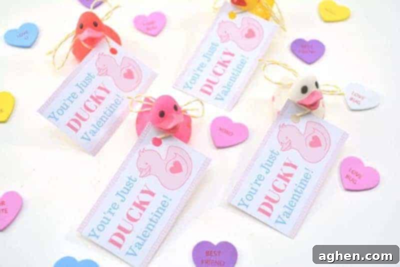 Adorable mini rubber duckies attached to 'You're Just Ducky' free printable Valentine cards, ready for kids to give out.